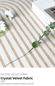 Detail of soft crystal velvet rug showing modern beige and brown curved stripe texture