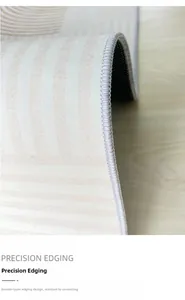 Detail of faux cashmere rug showing precision double-layer grey stitching on beige stripes