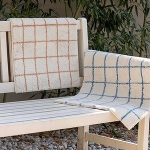 Minimalist checkered faux cashmere rug in beige with blue and orange grid patterns