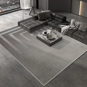 Close-up of light grey geometric rug showing fine fabric texture and edge stitching