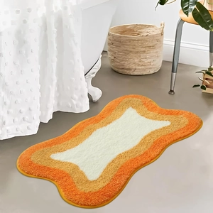 Modern minimalist faux cashmere wave-shaped bath mat with plush orange and brown layers