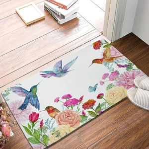 Detail of floral diatom mud mat with hummingbird design on rustic wooden floor