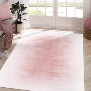Detail of pink and white gradient rug with distressed texture in modern home setting