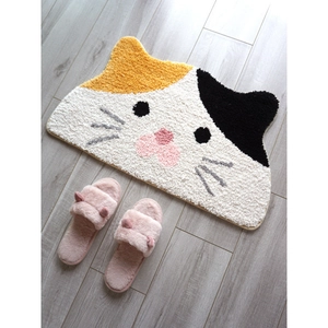 Cute calico cat shaped non-slip floor mat with matching pink plush slippers on wooden floor