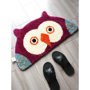 Macro view of purple owl-shaped tufted rug with thick pile and absorbent texture