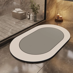 Detail view of oval diatom mud bath mat with minimalist dual-tone grey and white design