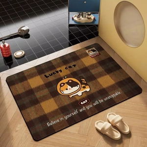 Detail of a brown plaid diatomite bath mat with a cute cartoon lucky cat and quote