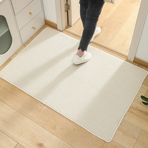 Non-slip sisal-style beige doormat with pineapple weave on a modern wooden floor