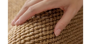 Close-up of thick sisal carpet texture showing the durable woven pattern and natural brown fibers