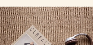 Detail of khakhi sisal texture woven rug with modern lifestyle accessories decor