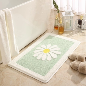 Green daisy bath mat with white floral pattern on marble floor for bathroom decor