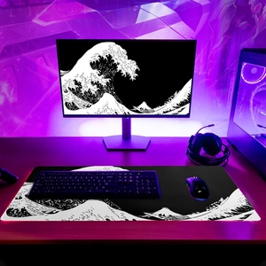 Detail of large Great Wave off Kanagawa desk mat under purple neon gaming room lights