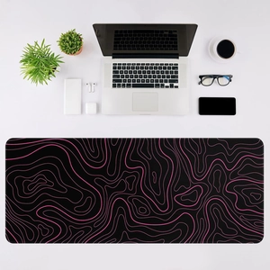 Close-up of extra-large black and pink topographic desk mat with durable stitched edges