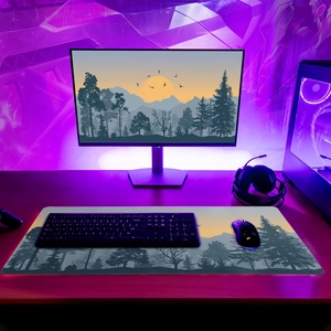 Extra large gaming desk mat with forest silhouette and non-slip rubber base
