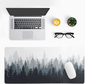 Detail of large desk mat with monochrome forest silhouette and stitched edges