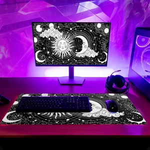 Detailed view of extra large sun and moon desk mat with black and white celestial pattern
