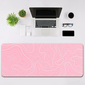 Pink topographic map desk mat with white contour lines for minimalist office setup