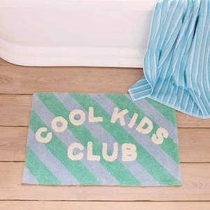 Detailed close-up of non-slip bath mat with thick flocking texture and cool kids club text