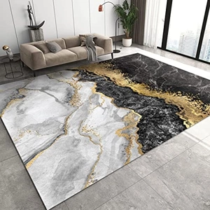 Détail du tapis moderne texture marbre avec motifs abstraits noirs, blancs et dorés