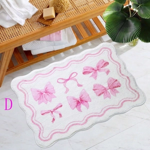 Detailed close-up of a pink bow pattern non-slip bath mat with wavy edges on marble floor