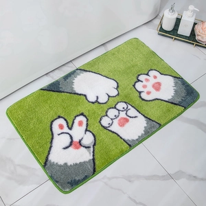Detail of soft plush cat paw bath mat on marble floor with 3D microfiber texture