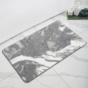 Close-up of grey and white marble pattern bathroom rug with high-density plush texture