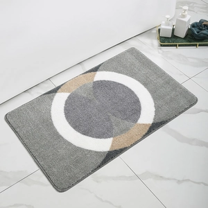 Detail view of modern grey geometric non-slip bath mat on marble bathroom floor