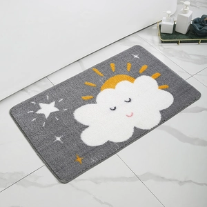 Detail of cute grey bath mat with sun and cloud patterns on marble floor