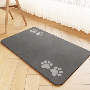 Detailed view of dark grey pet feeding mat with paw prints on wood floor