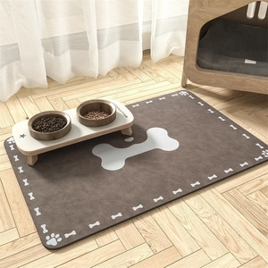 Detailed close-up of brown pet feeding mat with white bone patterns on wood floor