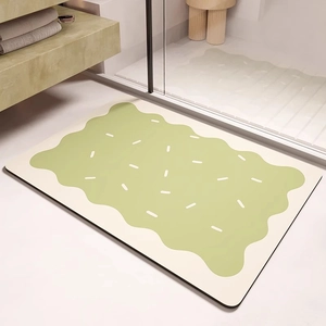 Détail du tapis de bain absorbant en boue de diatomée avec motif biscuit vert et texture