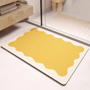 Détail de vagues jaunes sur tapis de bain en terre de diatomée à texture absorbante