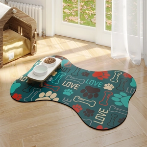Bone-shaped absorbent pet feeding mat with colorful paw prints on dark teal background