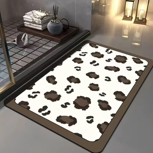 Detailed close-up of leopard print bath mat with rounded edges in modern bathroom setting