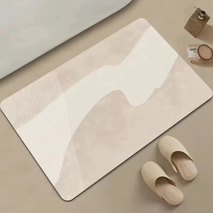 Minimalist cream diatomite bath mat with abstract flowing lines in a lifestyle home setting