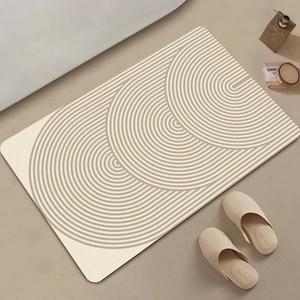 Detailed close-up of beige geometric diatom mud bath mat with rapid water absorption