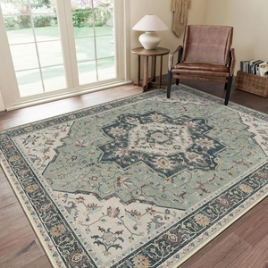Close-up of sage green bohemian Persian rug with vintage medallion on wood floor