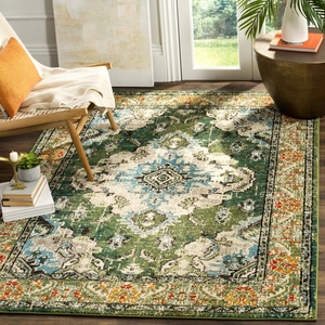 Close-up of vintage Persian rug with dark green medallion pattern on wood floor