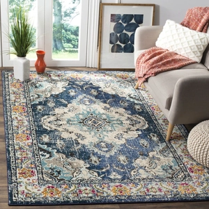 Detail of vintage Persian style rug with distressed blue patterns on wooden floor
