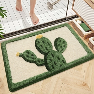 Close-up of thick plush bath mat with cactus pattern and non-slip green border