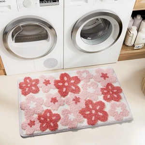 Detailed plush bathroom mat with red and white floral pattern in a laundry room