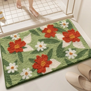 Floral anti-slip bathroom mat with green base and tufted orange flowers for home decor