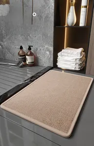 Detail of beige diatom mud pet mat with weave texture and precise edge stitching