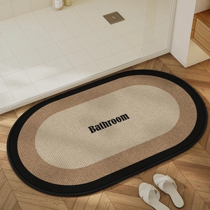 Detail of oval absorbent bathroom mat with woven linen texture and non-slip backing