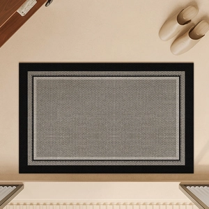 Close-up of woven linen texture and black border detail on the grey bathroom floor mat