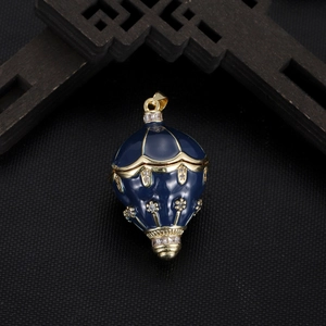 Deep blue enamel hot air balloon pendant with gold floral relief and white zircons
