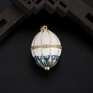 Macro detail of Faberge style egg pendant with blue enamel and crystal inlay