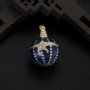 Detail view of a blue enamel egg-shaped pendant with gold star inlay and zircon crystals
