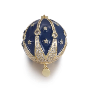 Detailed view of navy blue enamel egg pendant with gold stars and sparkling stones