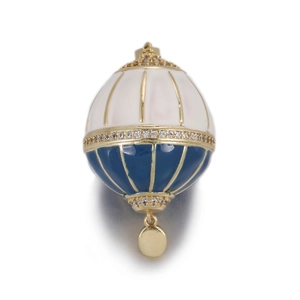 Detailed view of a gold hot air balloon pendant with blue and white enamel and zircons